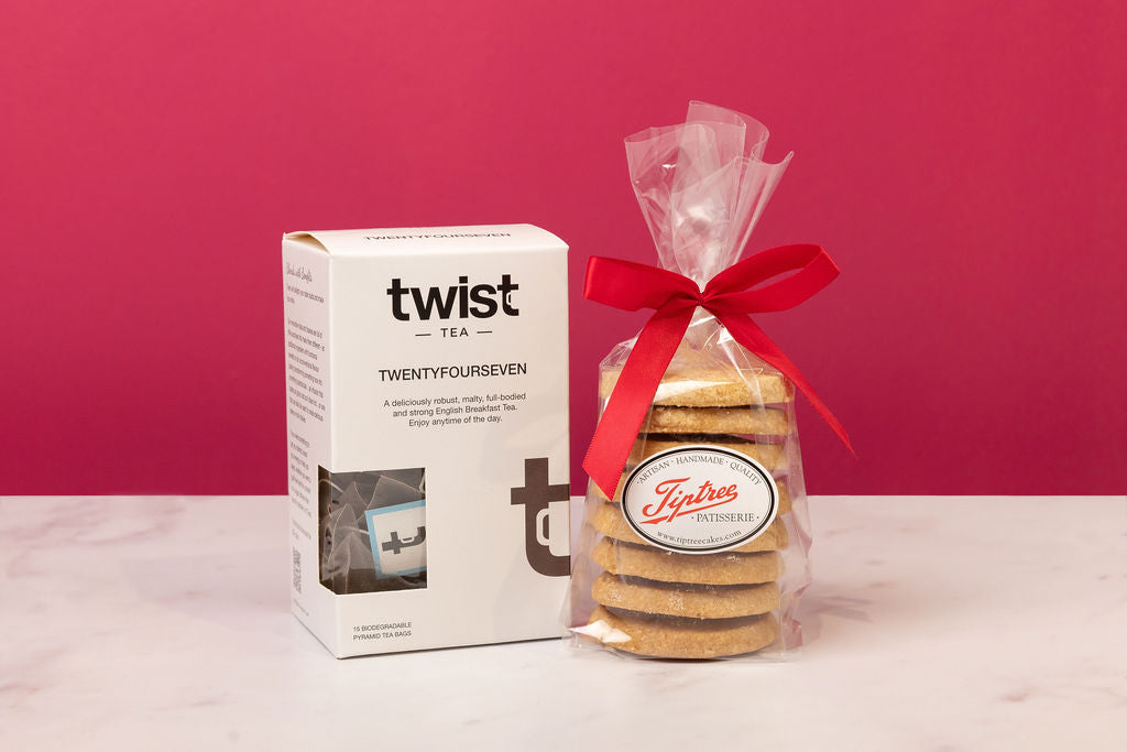 Twist Tea box and bag of cookies on a pink background