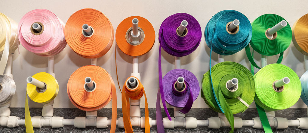 Colourful spools of ribbon used at Stort Valley Gifting on a white background 