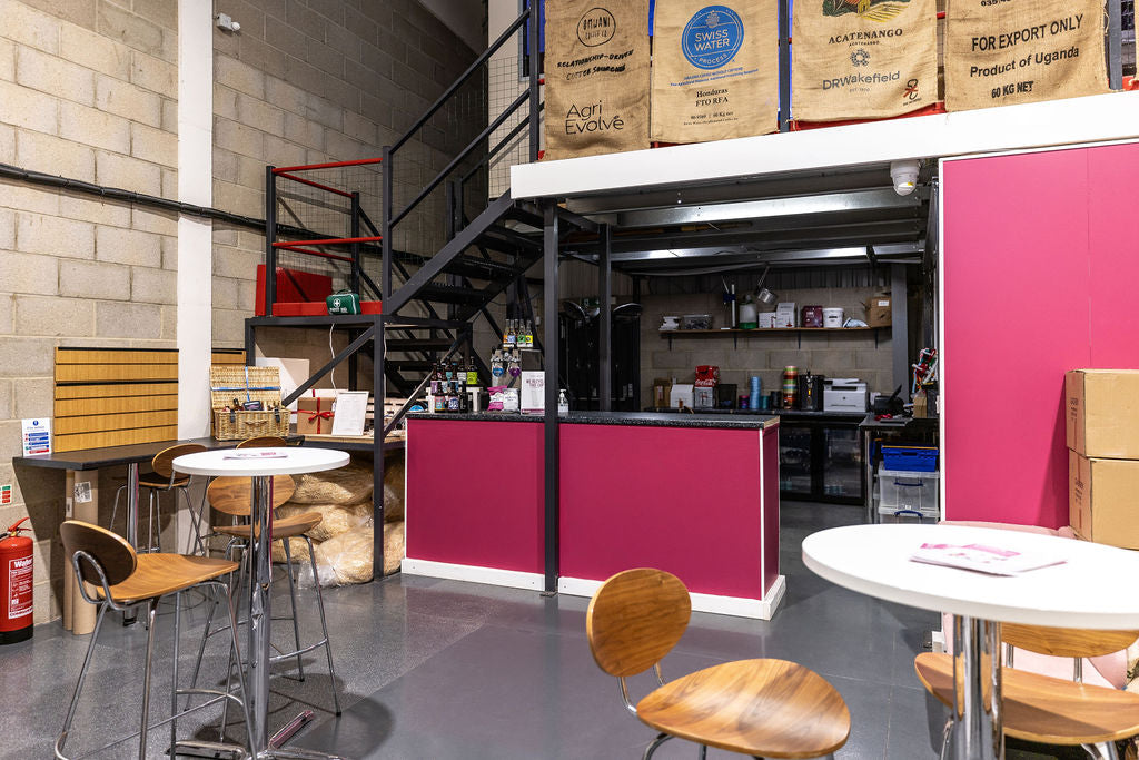 The bar and event space with high tables and chairs in the Stort Valley Gifting Hamper Hub