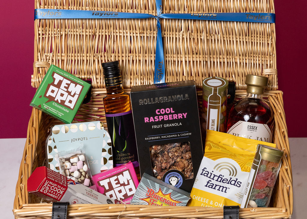 Stort Valley Gift basket with personalised ribbon and various items including bottles and boxes on a red background