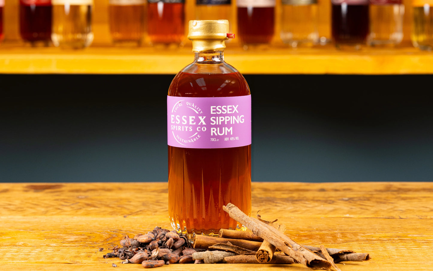 Bottle of Essex Sipping Rum on a wooden surface with cinnamon sticks available at Stort Valley Gifting