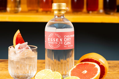 Bottle of Essex Dry Gin with a cocktail and fruit on a bar counter available at Stort Valley Gifting