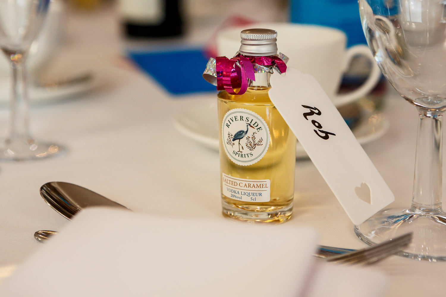 Personalised Stort Valley  Miniature bottle of Riverside Spirit on a table with cutlery and glasses.