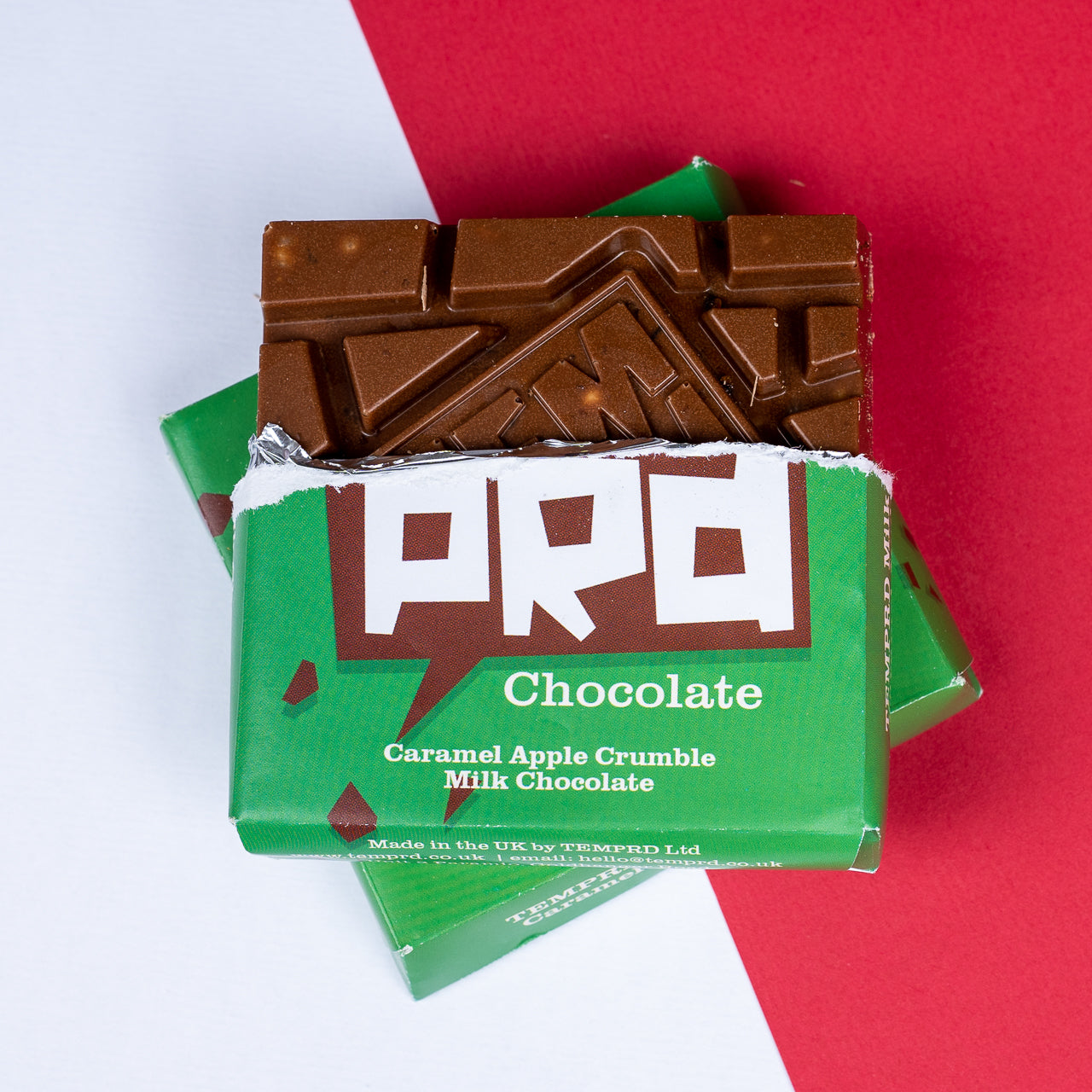 Temprd Caramel Apple Crumble Milk Chocolate bar with green packaging on a red and white background available from Stort Valley Gifting