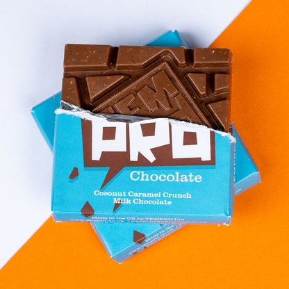 Temprd coconut caramel crunch milk Chocolate bar with a blue wrapper on an orange and white background available from Stort Valley Gifting 