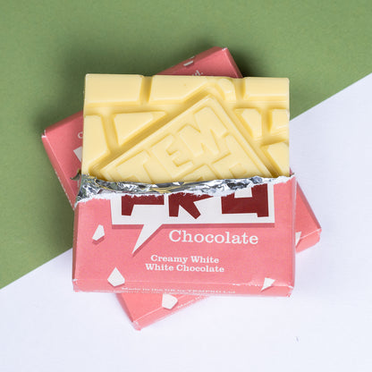 Bar of Temprd creamy white chocolate in a pink packaging on a green and white background available from Stort Valley Gifting
