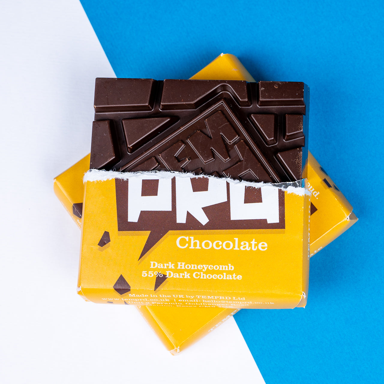 Temprd Dark Honeycomb chocolate bars in a yellow Chocolate packaging on a blue and white background available from Stort Valley Gifting