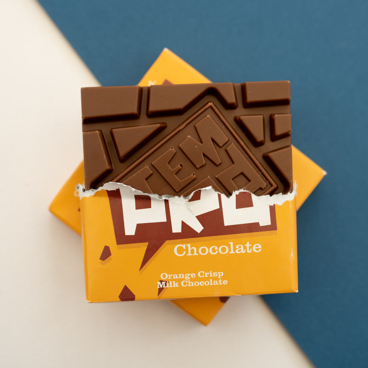 Temprd  ORange Crisp Chocolate bar in orange packaging against a blue and white background available from Stort Valley Gifting