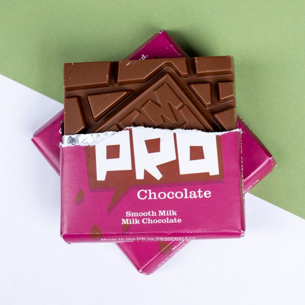 Open pink chocolate bar packaging with a Temprd milk chocolate bar inside on a green and white background available from Stort Valley Gifting