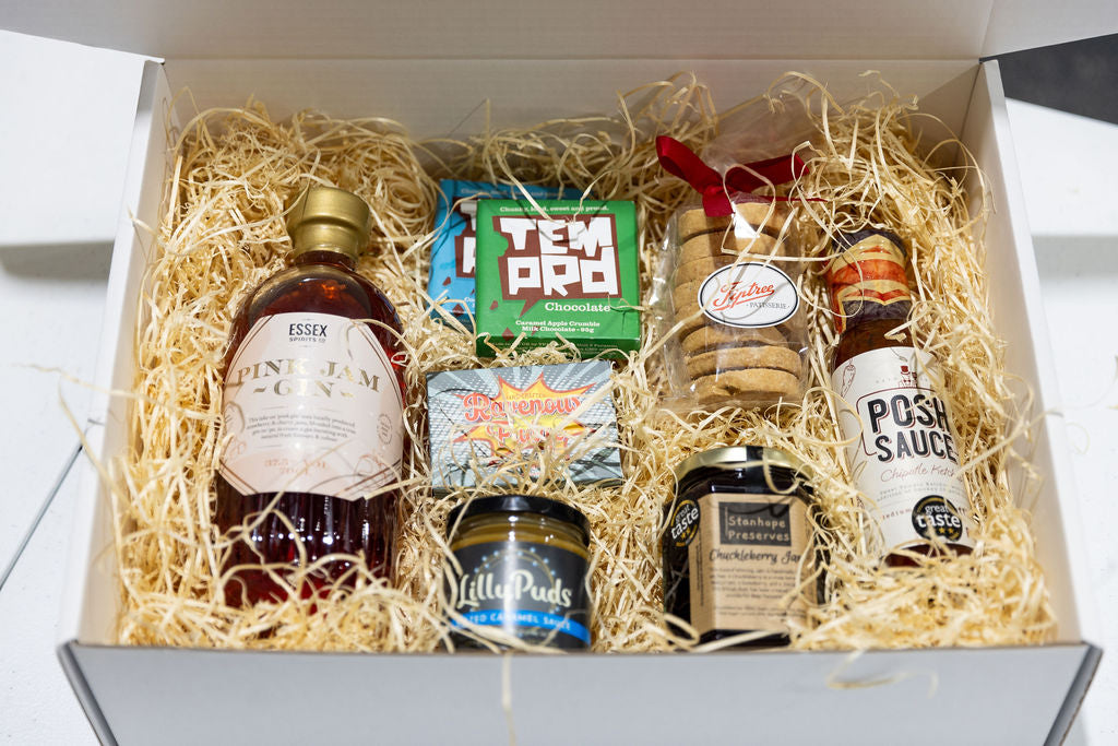 Personalised Stort Valley Gift box with assorted items including a bottle of gin, snacks, and condiments.